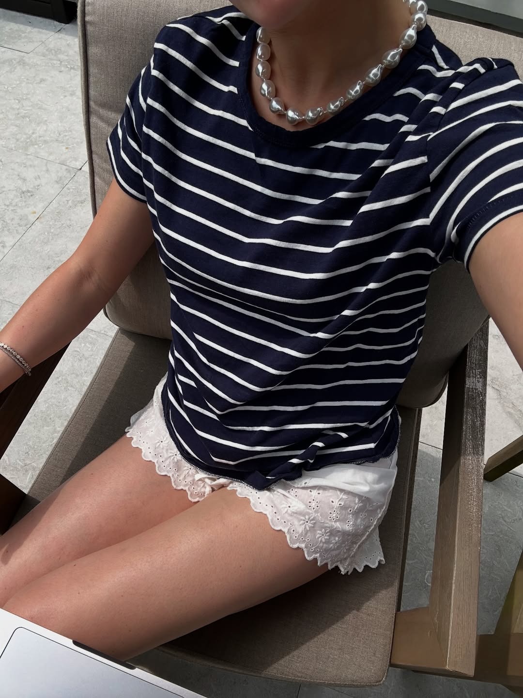 Woman in embroidered shorts and striped tee