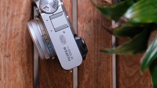 Fujifilm X100VI camera on a slatted wooden table