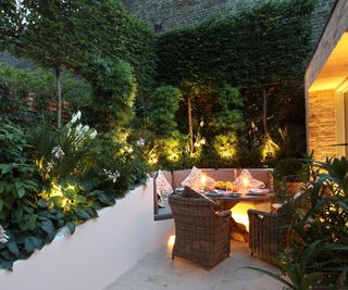 A small courtyard garden with built in raised beds and seating area