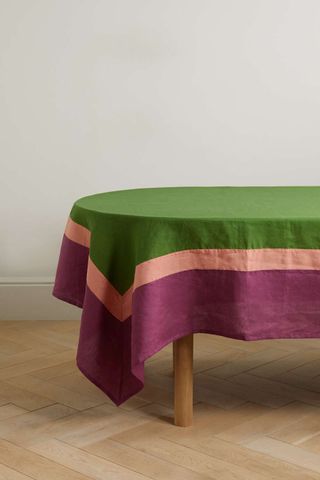 linen tablecloth in 3 block colors in a striped design draped over an oval table