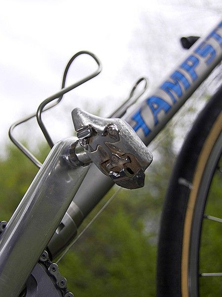 Old-school Dura-Ace SPD pedals allow the use of recessed cleats for easier walking while on tours.