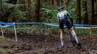 Cyclocross racer cornering in mud