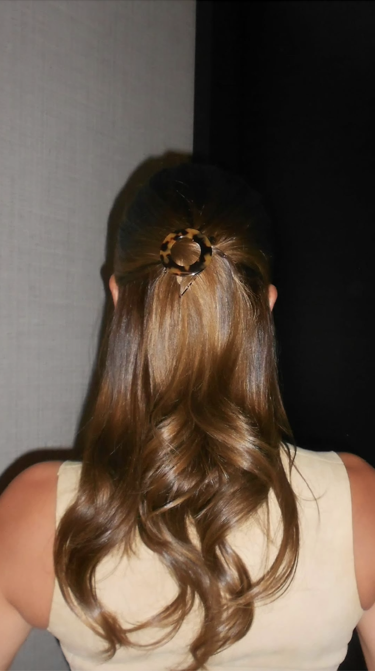 Hailey Bieber with a half-up, half-down hairstyle with a tortoiseshell barette