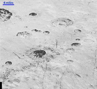 This highest-resolution image from NASA’s New Horizons spacecraft reveals new details of Pluto’s rugged, icy cratered plains, including layering in the interior walls of many craters.