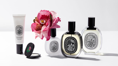 Diptyque rose collection on white table against white background with pink flower 