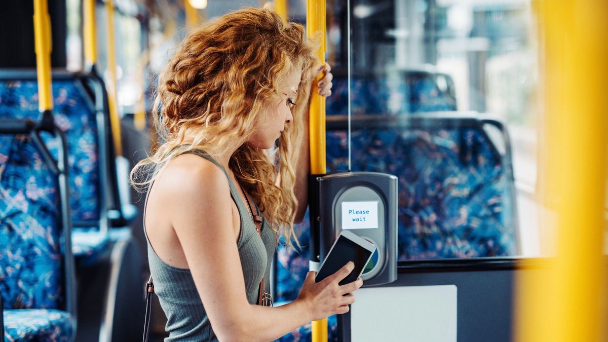 Woman using contactless card payment for public transport