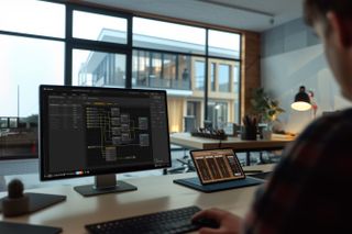 A user using the latest QUESTRA update on an office desk.