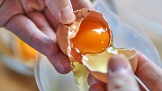 Person seperates egg yolk