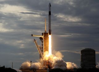 a rocket lifts off from a launch pad