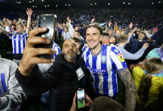 SHEFFIELD, ENGLAND - MAY 18: Aden Flint of Sheffield Wednesday celebrates on the pitch with fans after winning a penalty shoot-out during the Sky Bet League One Play-Off Semi-Final Second Leg match between Sheffield Wednesday and Peterborough United at Hillsborough on May 18, 2023 in Sheffield, England. (Photo by Matt McNulty/Getty Images)