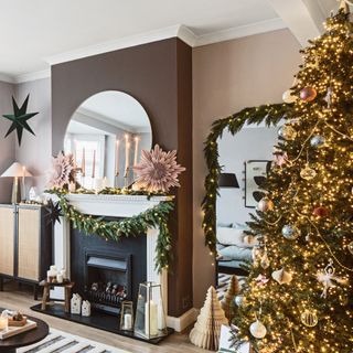 living room with Christmas tree, garlands, and paper decorations