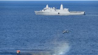 On Dec. 11, 2022, NASA's Orion spacecraft for the uncrewed Artemis 1 mission splashed down in the Pacific Ocean with the USS Portland seen in the distance after a 25.5-day flight to lunar orbit and back.