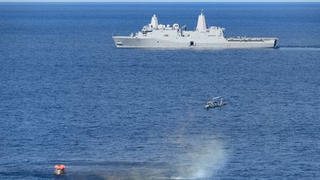 On Dec. 11, 2022, NASA's Orion spacecraft for the uncrewed Artemis 1 mission splashed down in the Pacific Ocean with the USS Portland seen in the distance after a 25.5-day flight to lunar orbit and back.