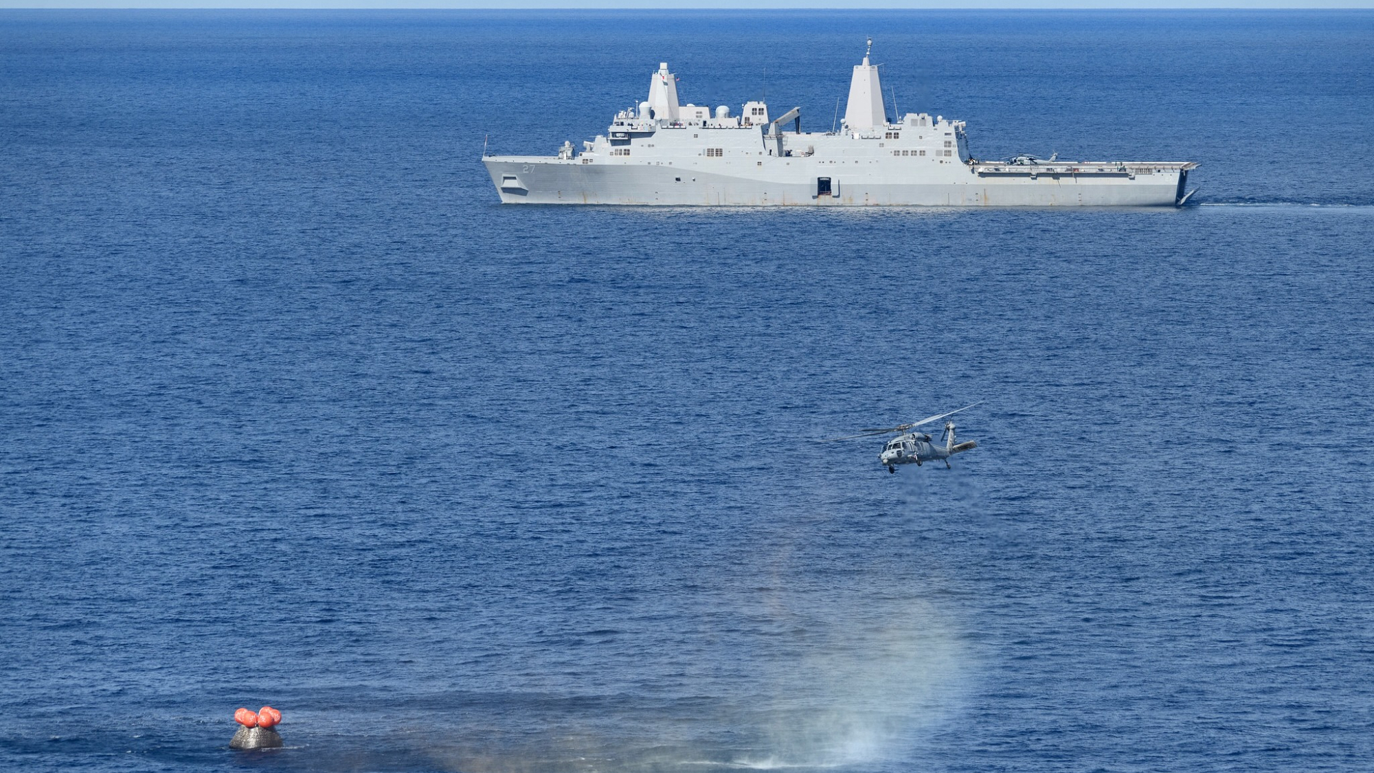 On Dec. 11, 2022, NASA's Orion spacecraft for the uncrewed Artemis 1 mission splashed down in the Pacific Ocean with the USS Portland seen in the distance after a 25.5-day flight to lunar orbit and back.