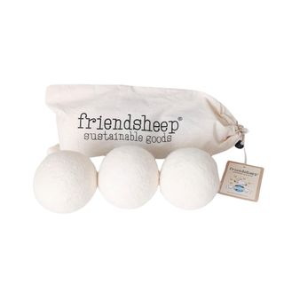 Three beige wool dryer balls with a beige cloth that has 'friendsheep sustainable goods' in black lettering on it behind them