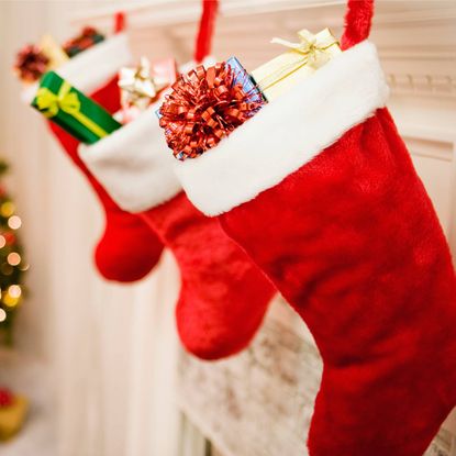 Stockings stuffed with presents hanging on a mantel