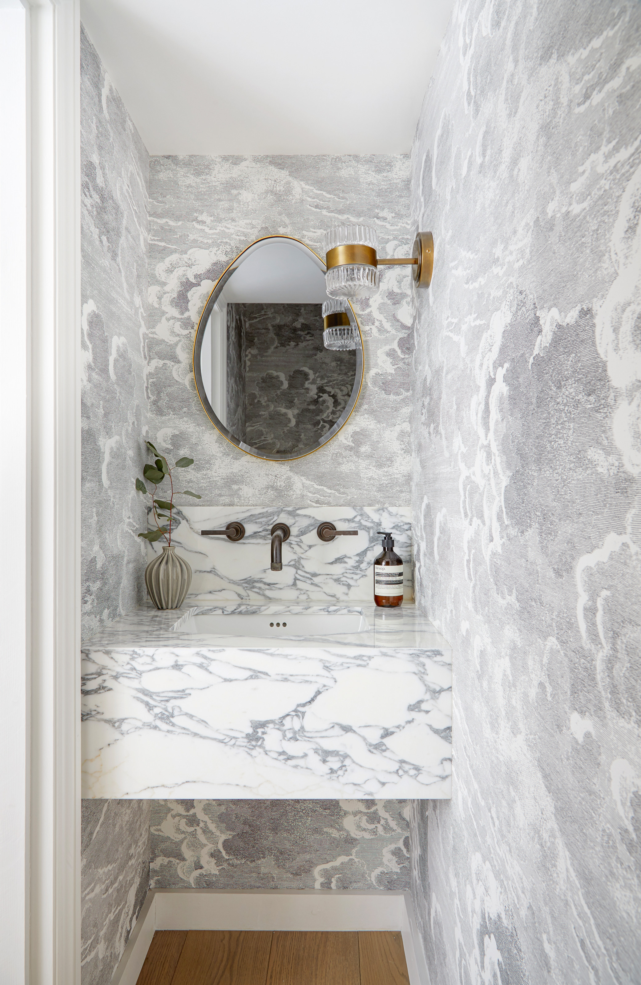 White marble bathroom with gold accents