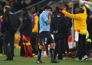 Luis Suarez walks off after his red card for handling the ball on the line in Uruguay's World Cup quarter-final against Ghana in 2010.