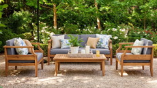 an outdoor seating arrangement with two chairs, a couch, and a coffee table