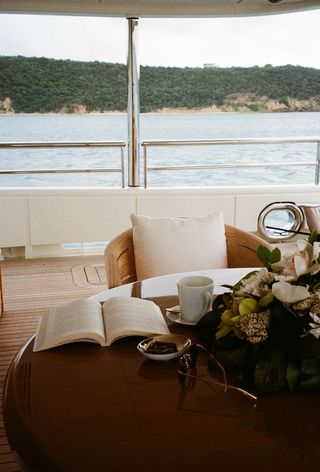 Table with book and tea on a boat