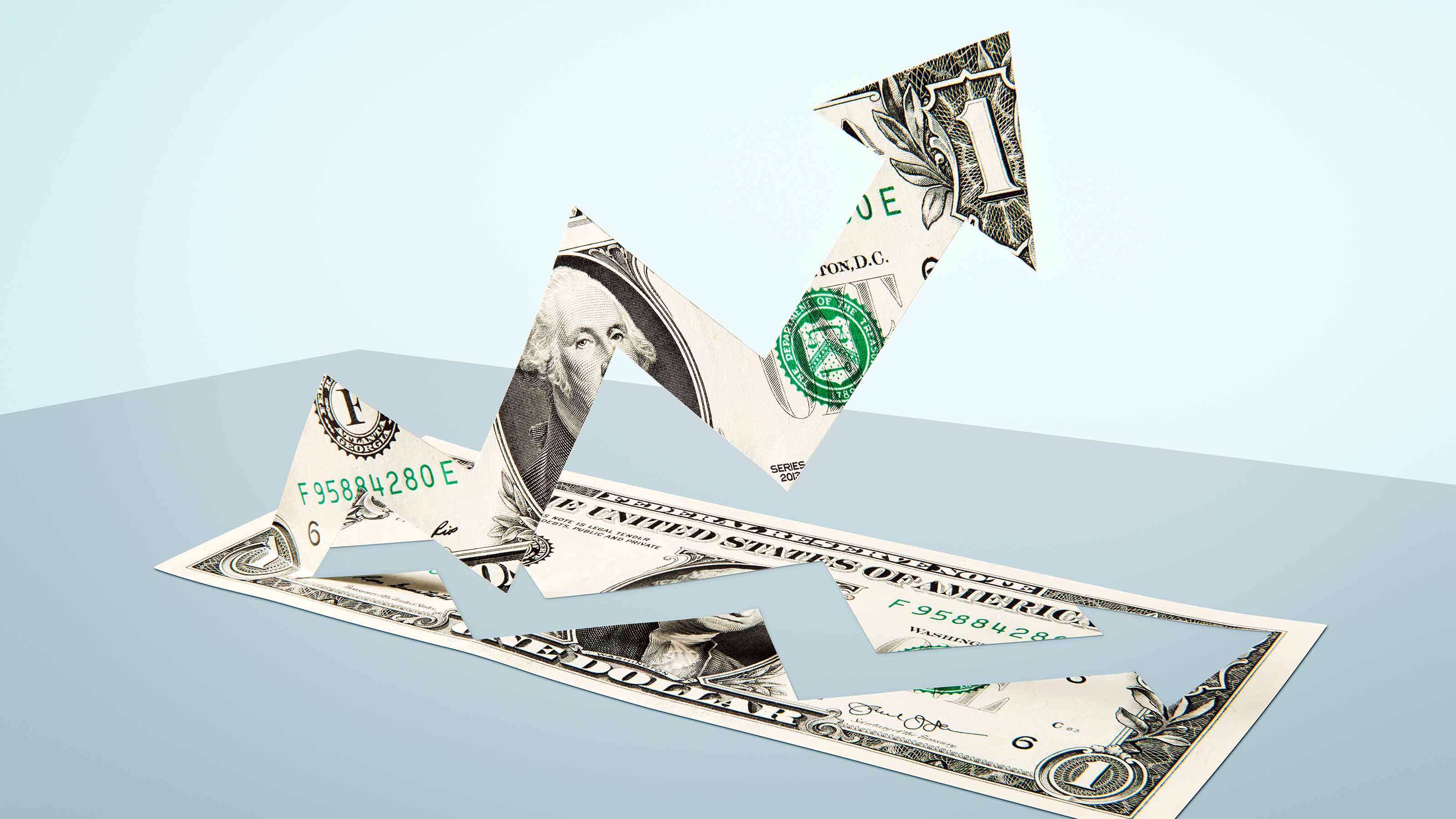 Dollar with middle cut out and formed into an arrow pointing up
