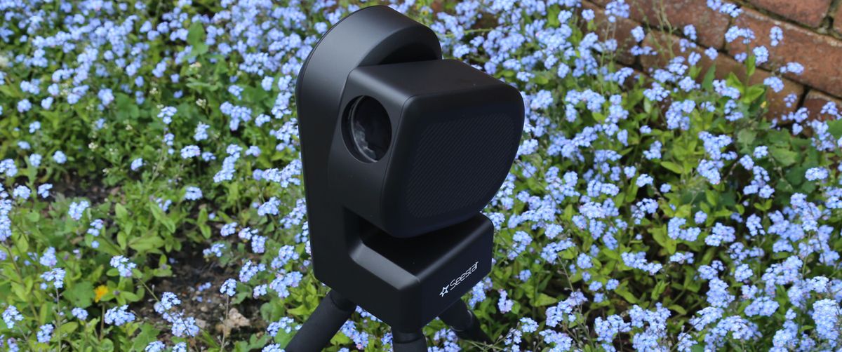 ZWO Seestar S50 telescope outside in a field of flowers