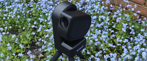 ZWO Seestar S50 telescope outside in a field of flowers