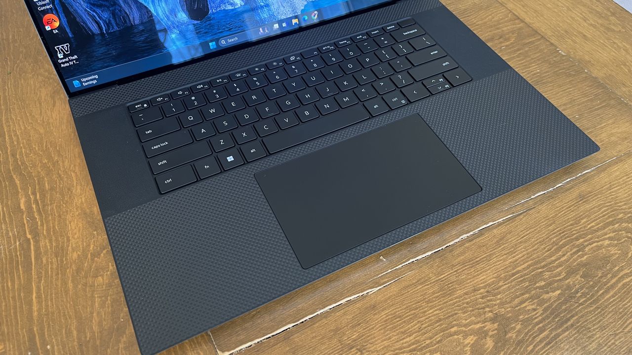 Dell XPS 17 laptop in use on a wooden desk