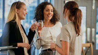 Woman drinking with friends, waiting between drinks before getting another one