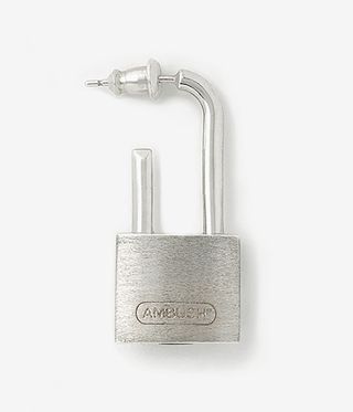 Silver padlock earring against a pale grey background