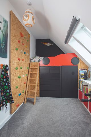 childrens bedroom with climbing wall and vaulted ceiling