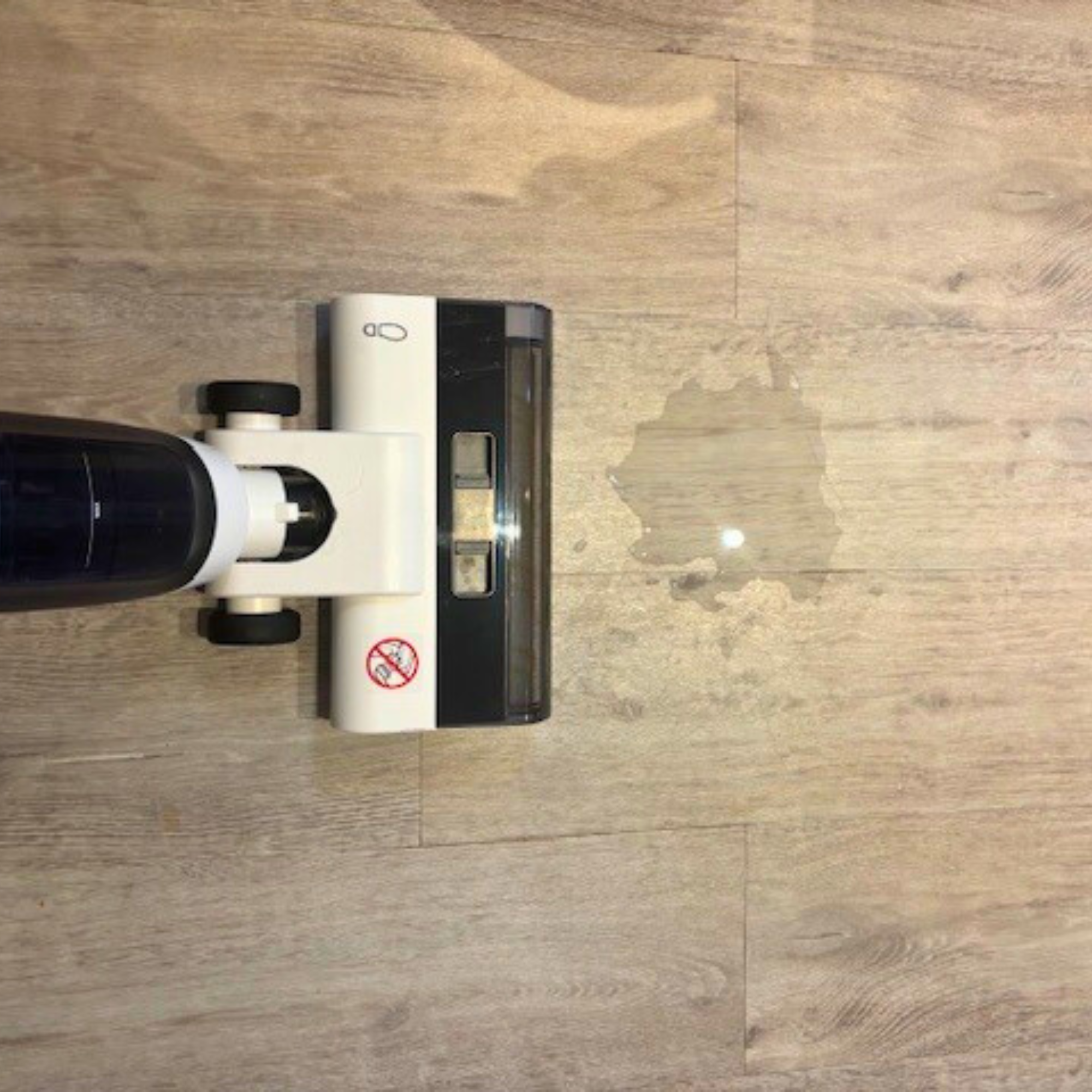 Kärcher Floor Cleaner Vacuum FCV 3 in front of water spill on laminate wood floor