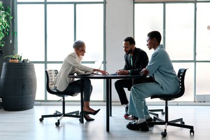 Elegant financial advisor during a meeting with clients in a modern office