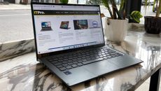 The Acer Swift 5 placed on a desk in a cafe, seen from a 45-degree angle