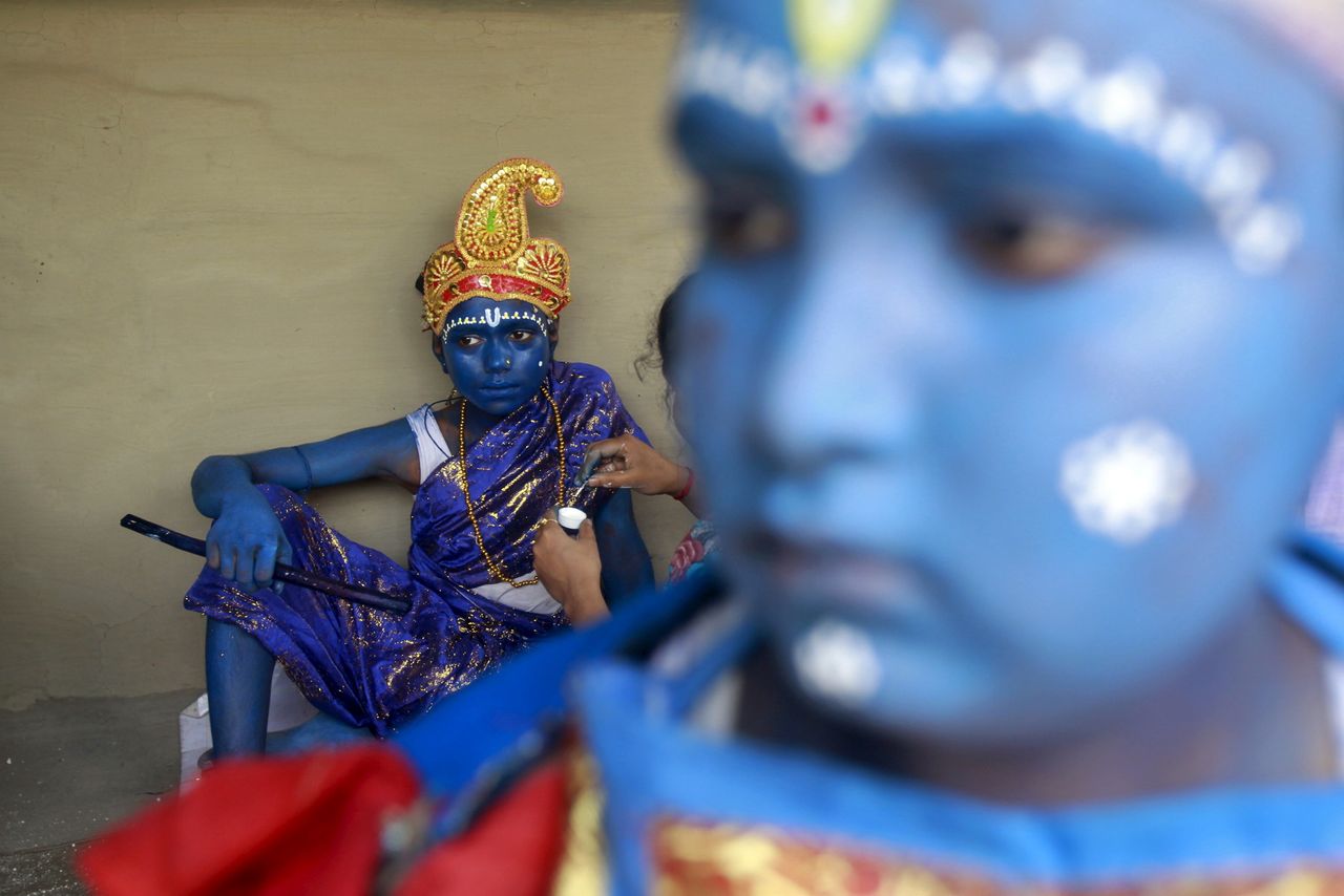 A Hindu girl has her face painted before taking part in a ritual.