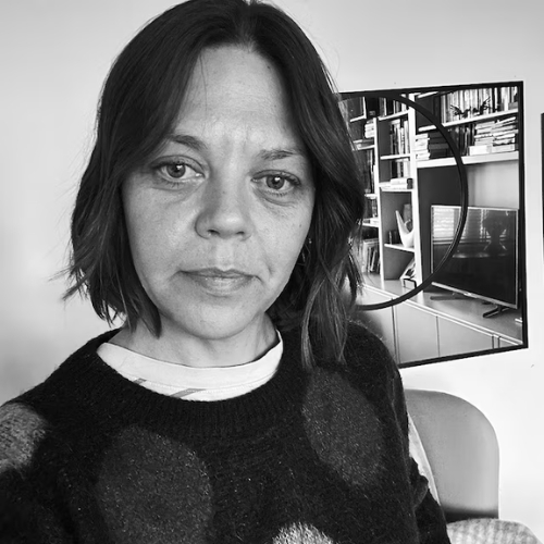 Black and white image of a woman in a black jumper.