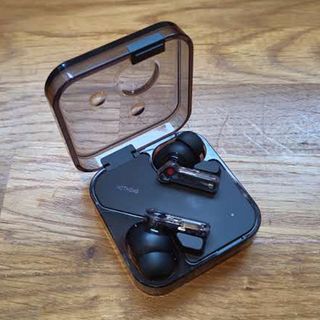 Nothing Ear review; black ear buds on a wooden table