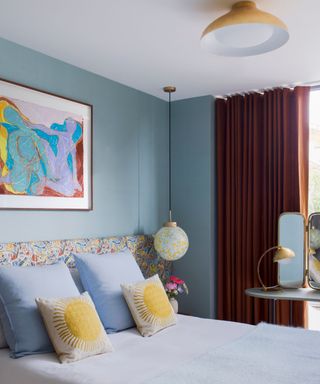 blue bedroom with pops of yellow and retro inspired decor