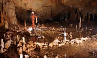 Scientists take measurements for the archaeo-magnetic survey in the Bruniquel Cave, where they found near-circular structures made of stalagmites.