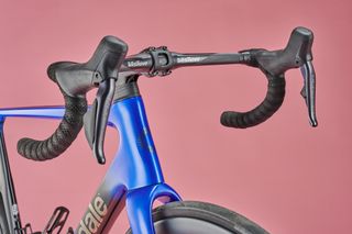 Cannondale SuperSix Evo Hi-Mod Ultegra Di2 on pink background,, close up of handlebars and front tyre clearance