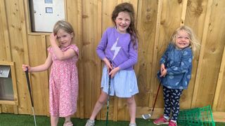 Three female junior golfers