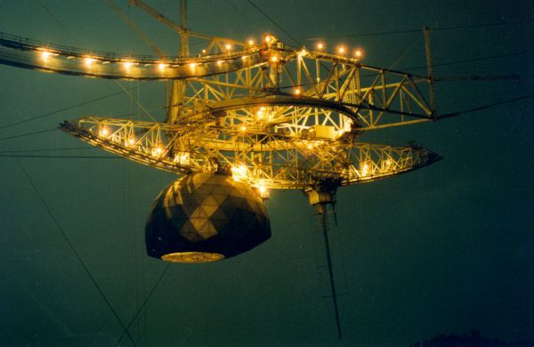 Arecibo Observatory&#039;s radio telescope&#039;s science platform illuminated at night.