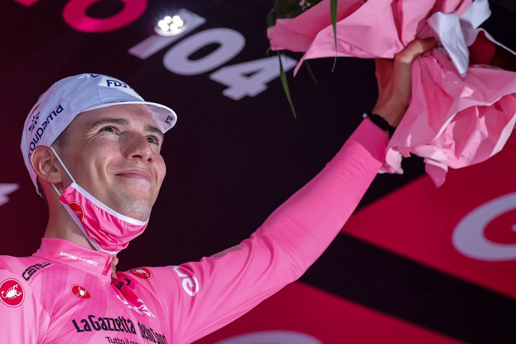 Team GroupamaFDJ rider Hungarys Attila Valter celebrates his overall leaders pink jersey on the podium on the podium after the eighth stage of the Giro dItalia 2021 cycling race 170 km between Foggia and Guardia Sanframondi on May 15 2021 Photo by Luca Bettini AFP Photo by LUCA BETTINIAFP via Getty Images