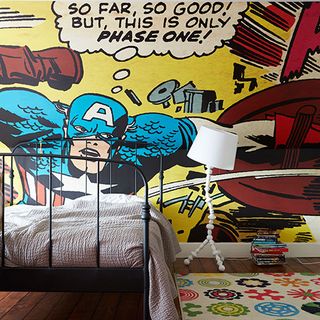 kids bedroom with marvel wallpaper and bed