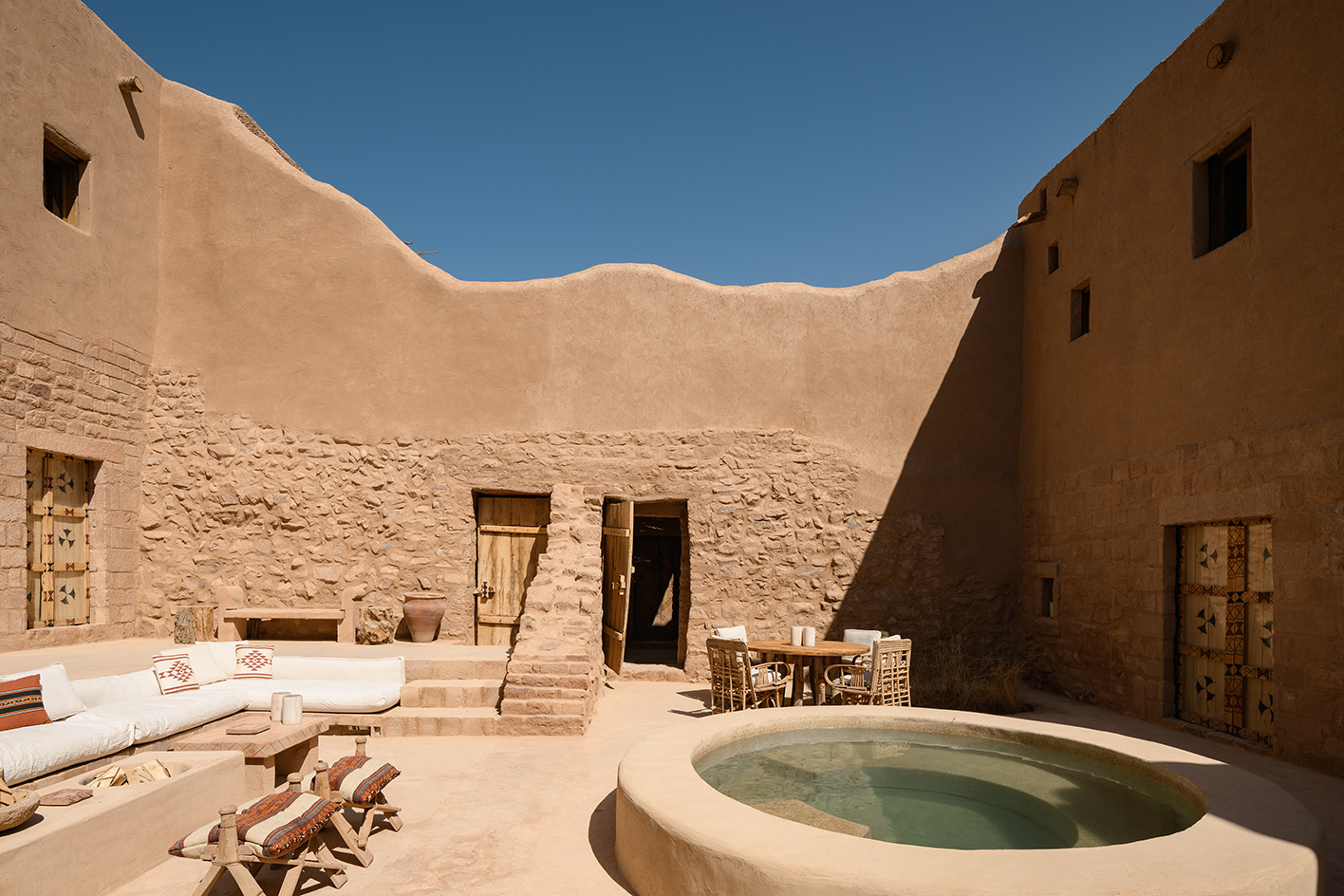 views of mud brick house with warm hues in desert building style, Bin Nouh's Courtyard House by Shahira Fahmy