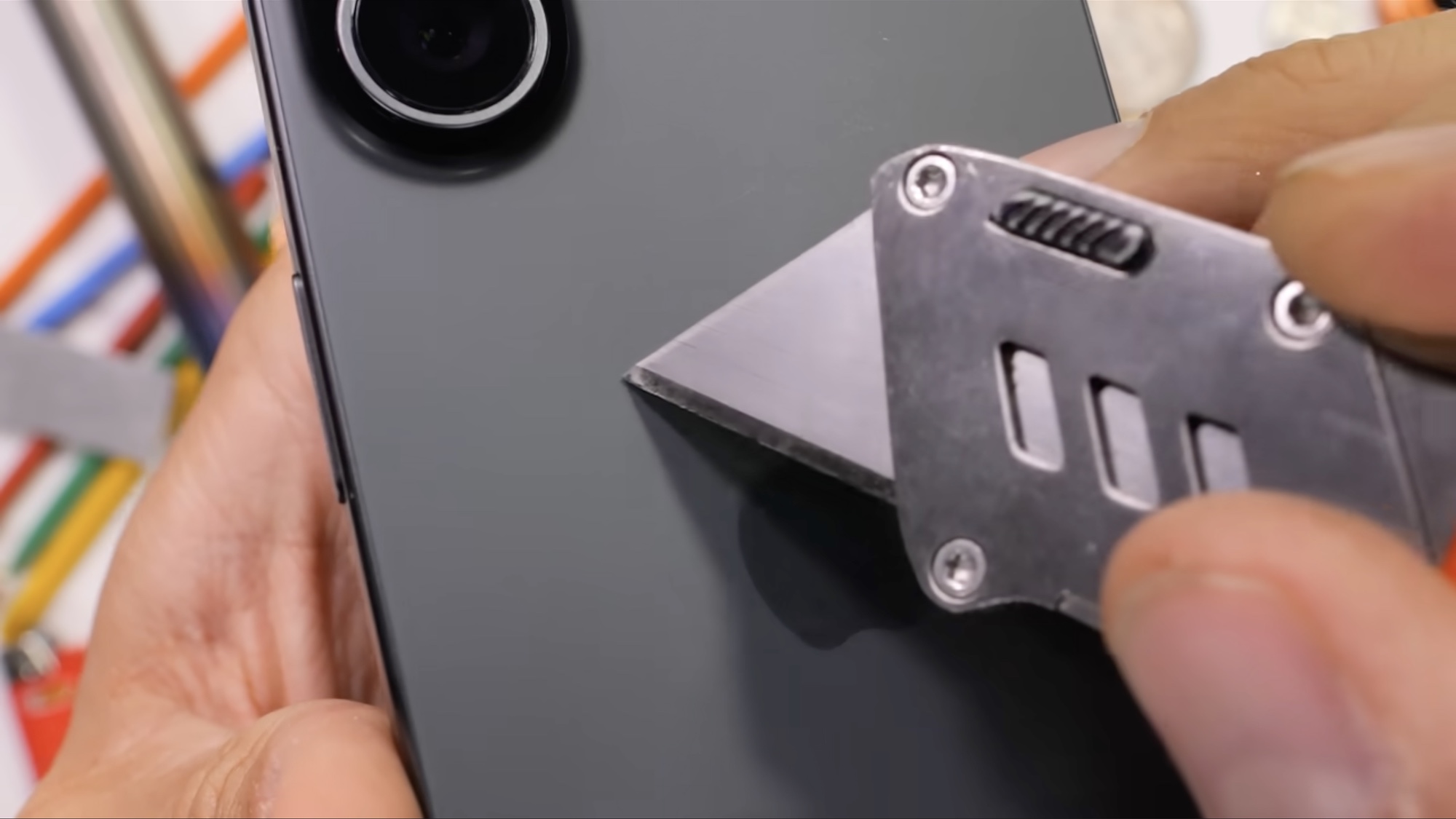 scratching the back of an iphone 17 in a JerryRigEverything video
