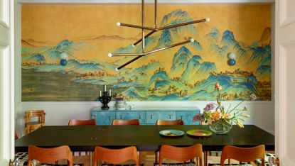 Dining room with tropical mural, rich wood chairs and black table