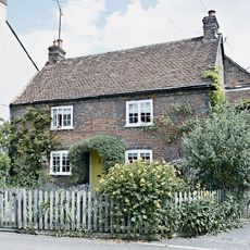 house exterior with garden and white windows