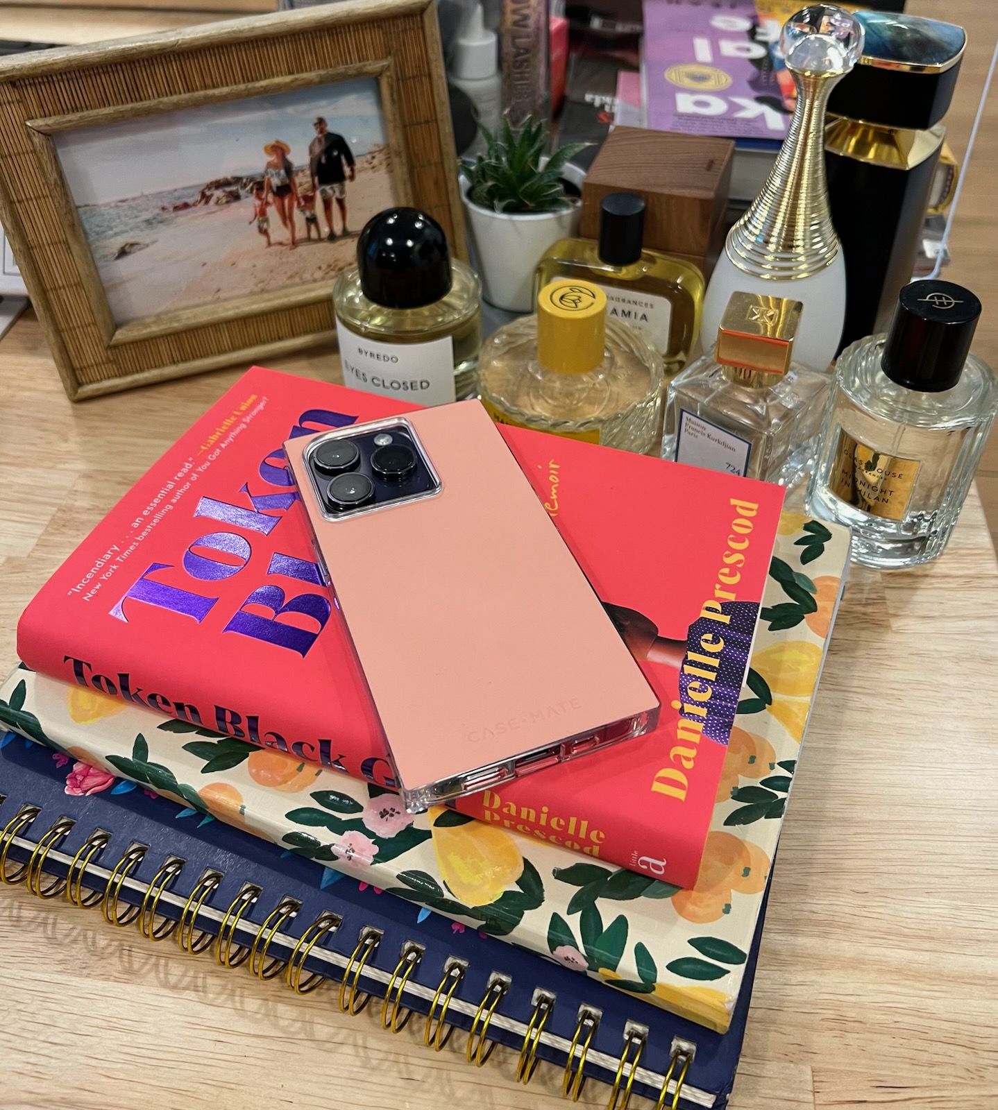 iPhone 14 on top of books on a desk