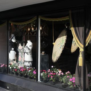Black shop front with yellow umbrella